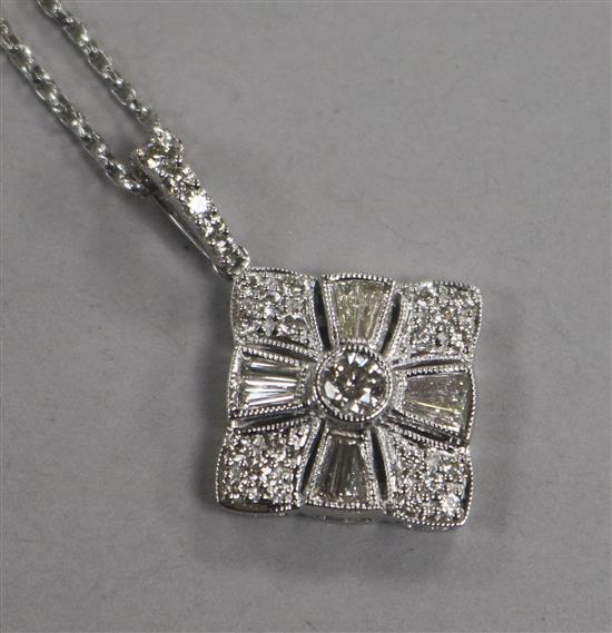 A modern 18ct white and diamond cluster pendant on a facetted 18ct white gold chain, pendant 19mm.